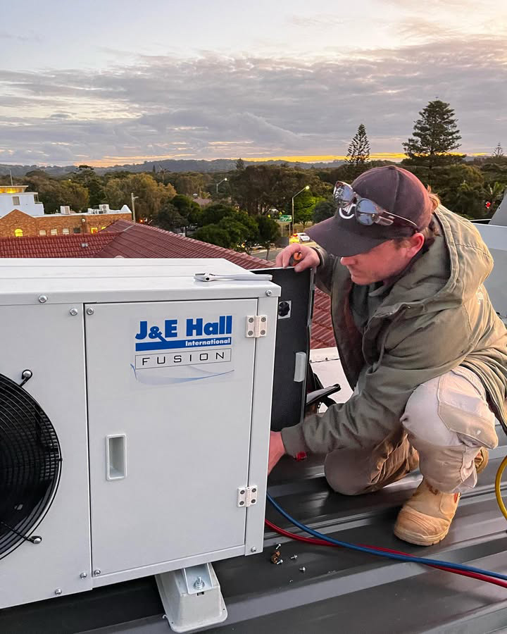 Licensed Technician Fixing Commercial Air Conditioner
