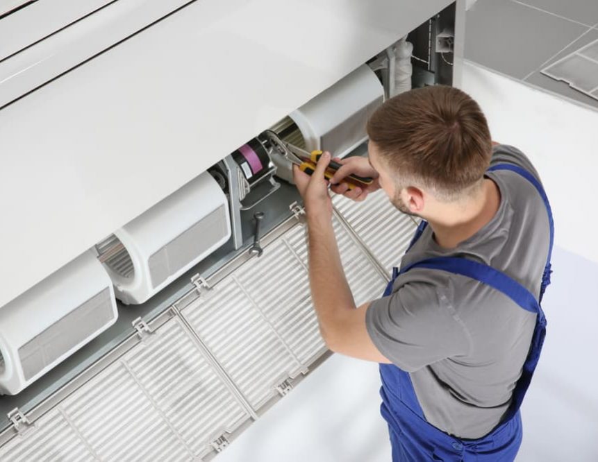 Industrial air conditioner getting fixed — Air Conditioning Solutions In Gold Coast, NSW