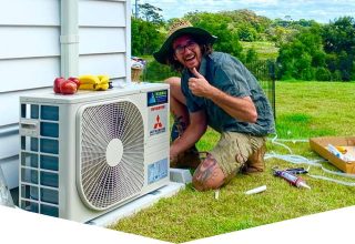 Man Fixing Aircon — Air Conditioning Solutions In Tweed Heads, NSW
